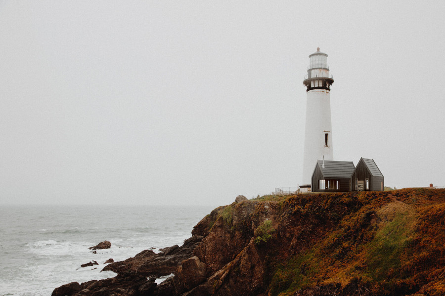 White lighthouse on a rocky cliff